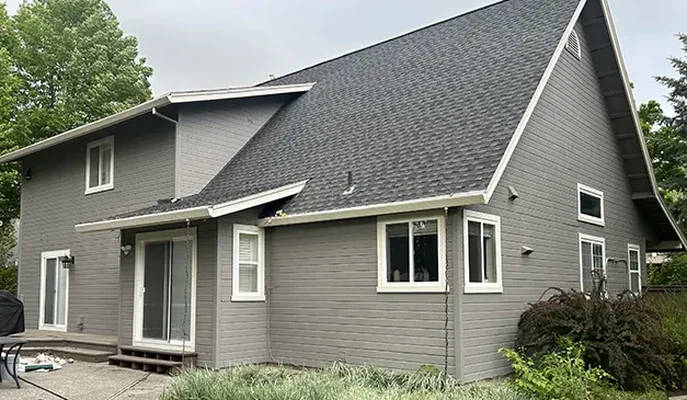 Two-story Spokane home with freshly painted grey siding and crisp white trim, photographed after a completed exterior painting project
