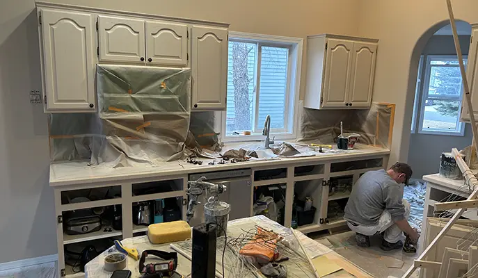 construction worker during work in kitchen interior painting