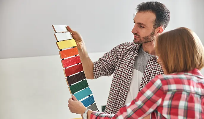 designer and client choose paint for house