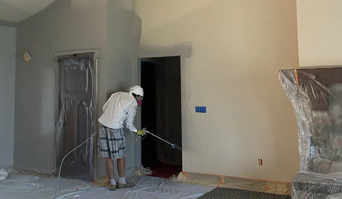 the painter is doing interior painting in grey