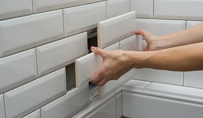 a builder installs facade tiles