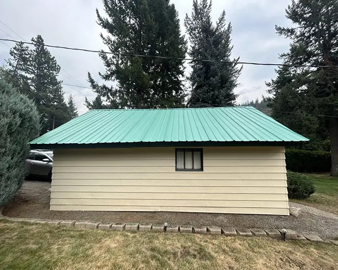 painted metal roof after cleaning from rust and moss