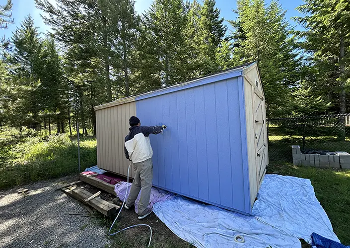 a painter paints a barn