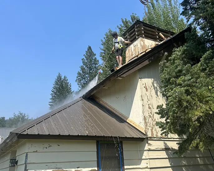 Roof cleaning service showcasing professional techniques for effective exterior maintenance and preparation for roof painting service.